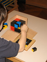 Montessori Child working on the Trinomial Cube